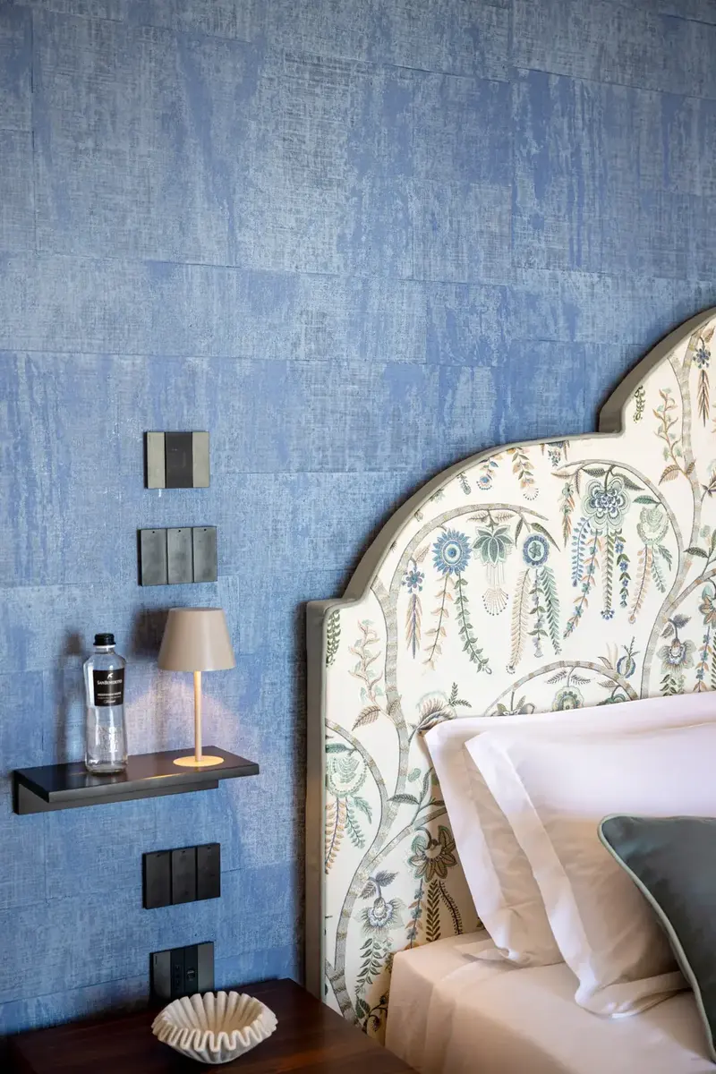 The headboard against the blue wall