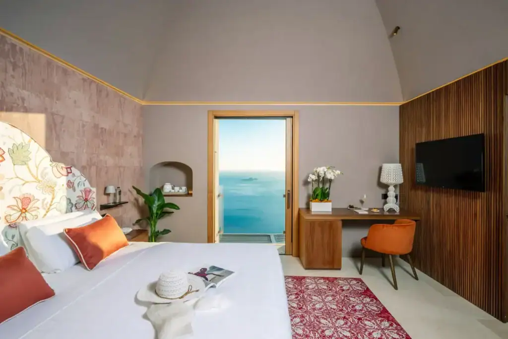Luxury hotel room with sea view, modern decor, and elegant furnishings.