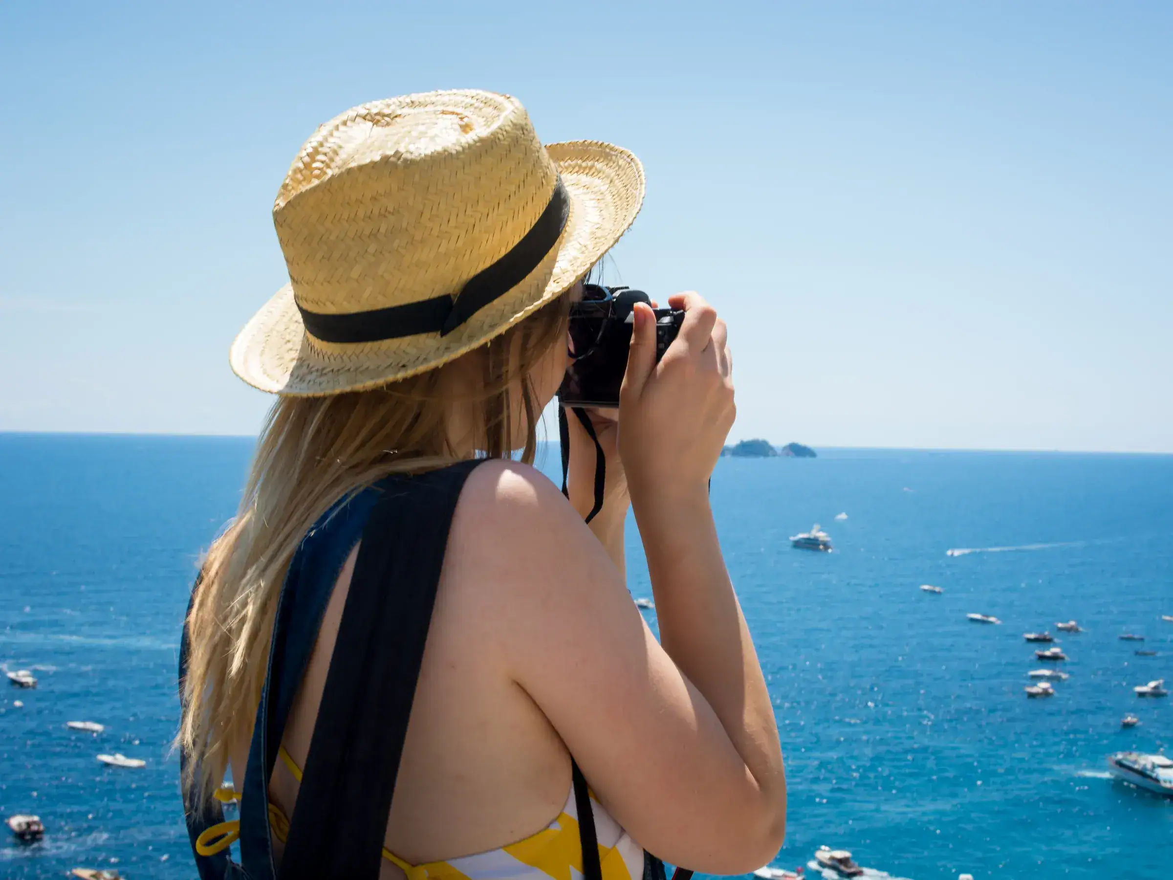 A visitor photographing the sea and Li Galli