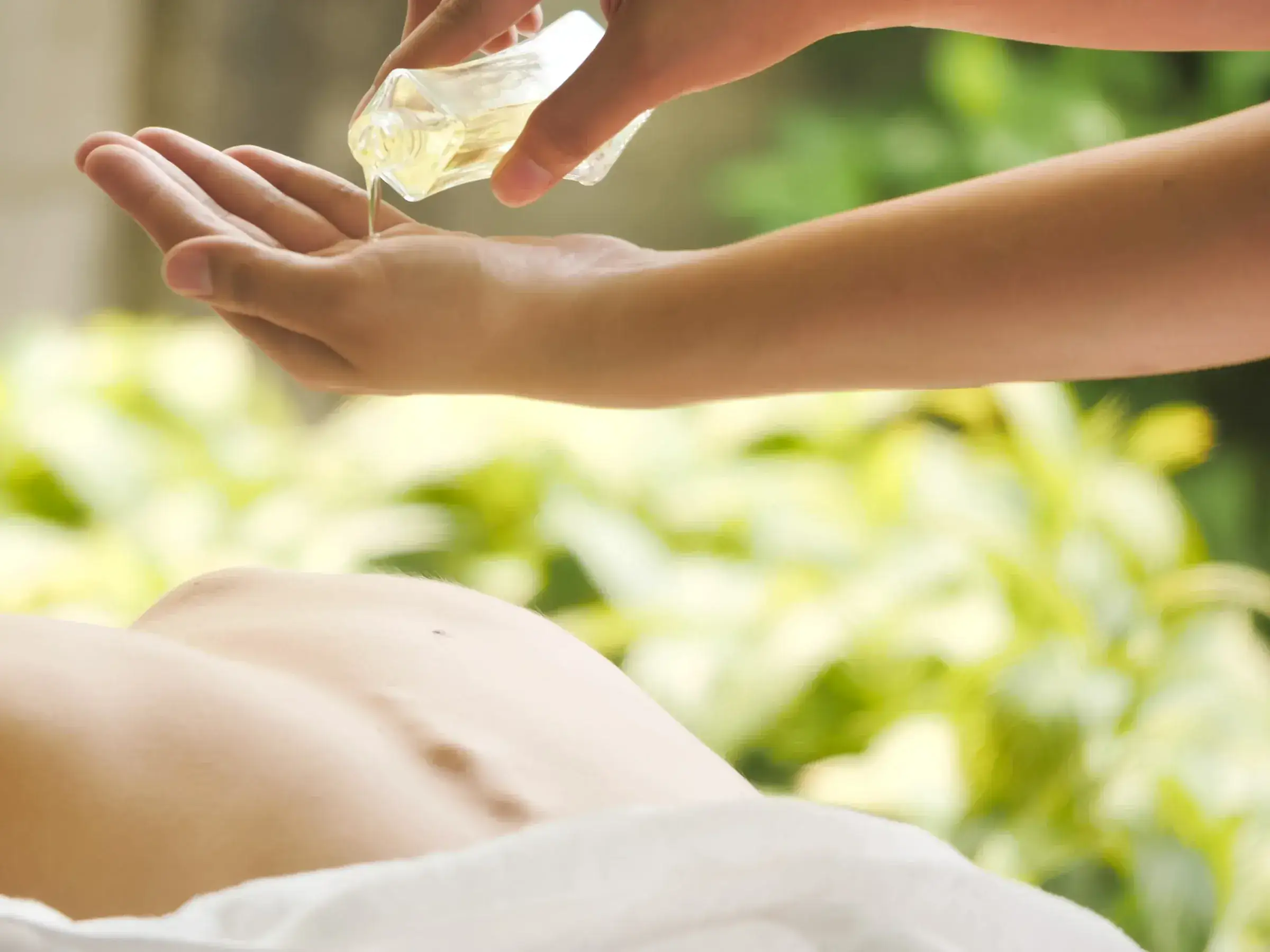A massage with oil, outdoors
